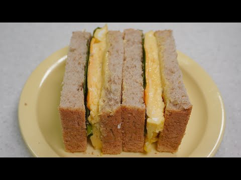 a scrambled egg sandwich full of eggs