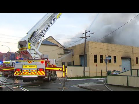 Commercial building fire spreading smoke across Sydney's inner west