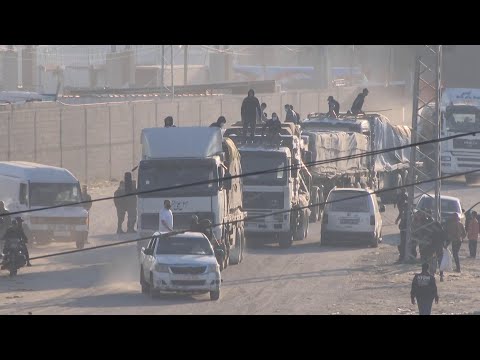 Aid trucks enter Gaza through the Rafah crossing, escorted by Hamas police