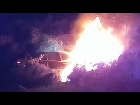 Dramatic video shows police rescue man from burning vehicle seconds before it's engulfed in flames