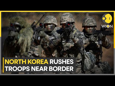 North Korea rushes troops, heavy weapons near border with South, warns of more satellite launches