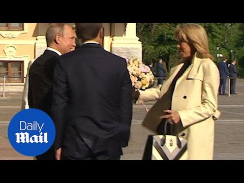 Putin gifts Brigitte Macron flowers as Emmanuel Macron visits Russia