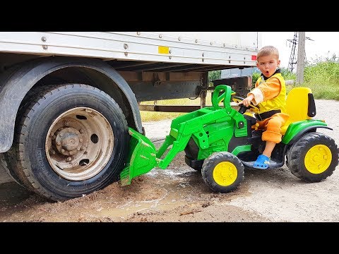 Truck stuck in the mud - Rubble ride on power wheels tractor to help