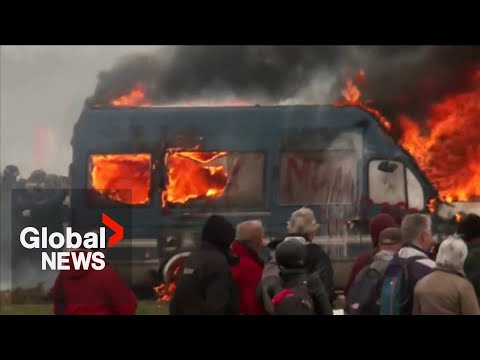 French protesters against farm water reservoir clash with riot police, set car on fire