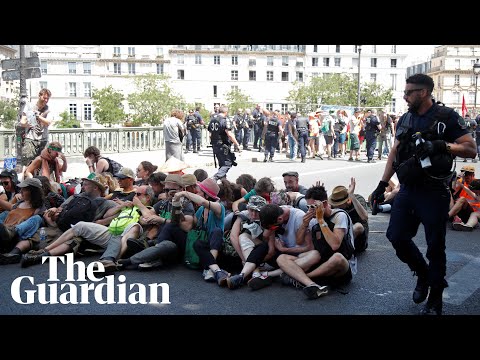 Police use pepper spray on seated climate protesters in Paris