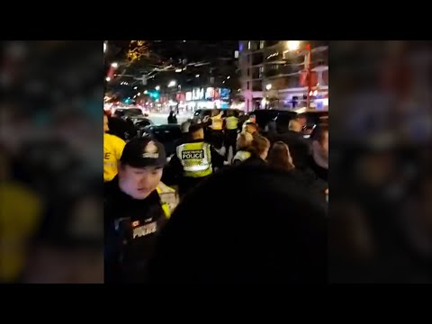 Justin Trudeau surrounded by protesters at Vancouver bar