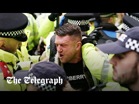 Police bundle Tommy Robinson out of the antisemitic London march as he's 'not welcome'