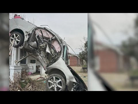 Car lands on house after hitting utility pole