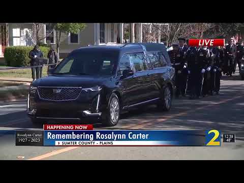 The Carter family walks behind Rosalynn Carter's hearse to escort her to her final resting place