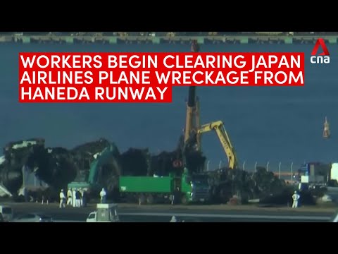 Japan Airlines collision: Workers begin clearing plane wreckage from Haneda Airport's runway