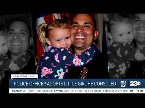 Police officer adopts little girl he consoled