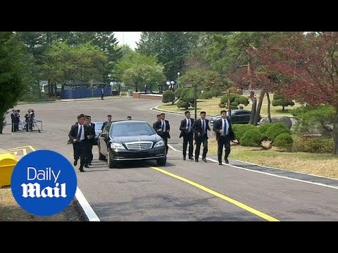 Kim Jong Un's body guards run alongside car carrying official