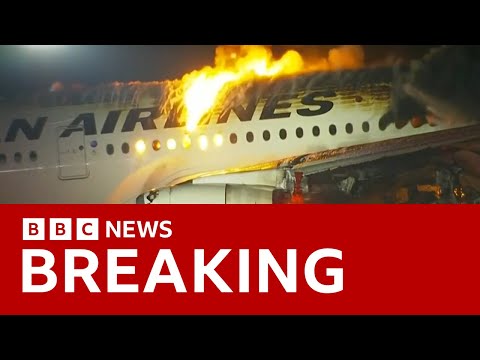 Japan Airlines plane in flames on the runway at Tokyo's Haneda Airport -BBC News