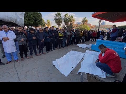 Palestinians perform prayers for the dead outside Al Aqsa Hospital in Gaza Strip