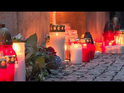 Czechs gather at evening vigil to pay respects to Prague shooting victims