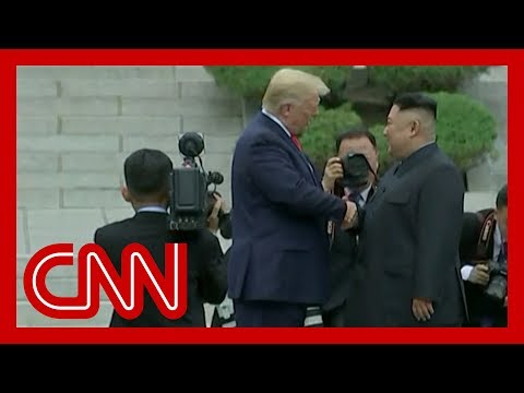 Trump and Kim Jong Un shake hands at DMZ