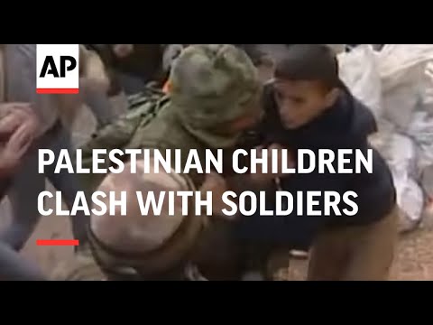 Palestinian children clash with soldiers at checkpoint