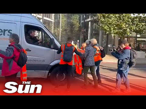 Protesters block fire engine and ambulance before van driver nudges them