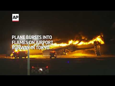 Plane bursts into flames on airport runway in Tokyo