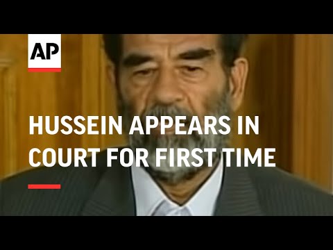 WRAP Defiant Saddam Hussein appears in court for first time