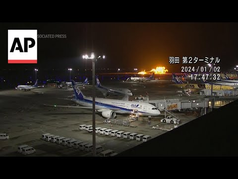 Plane catches fire as it lands at Tokyo's Haneda airport