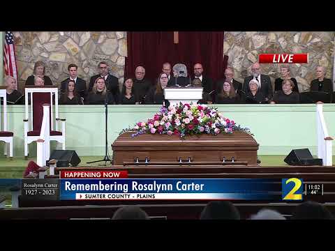 The Carter family escorts former President Jimmy Carter into funeral service for Rosalynn Carter