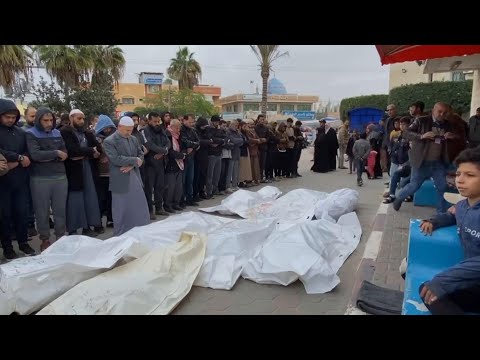 People perform funeral prayers in front of Al Aqsa Hospital in Gaza